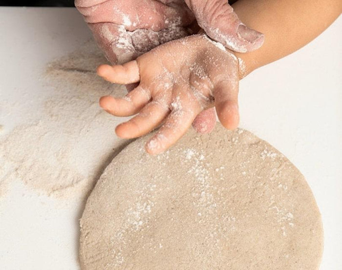 Child making Eco-kids A Day at the Beach Kit sand casting medium