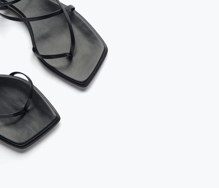 Black calf leather Alexia sandal by Freda Salvador with sleek strap details and a comfortable open-toe design.