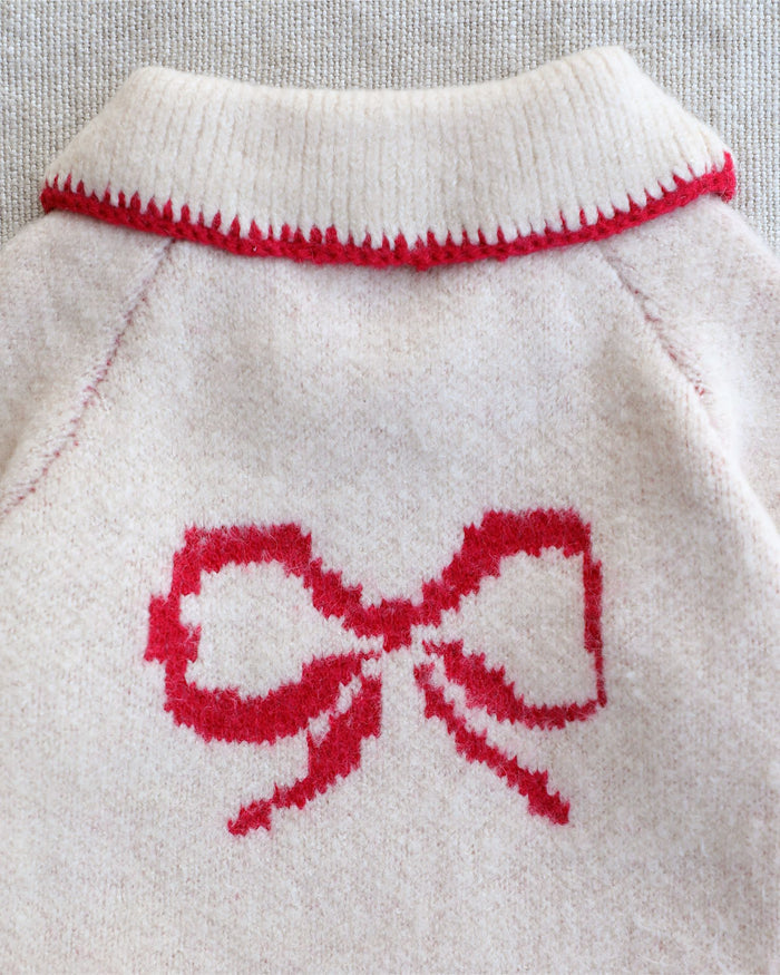 Holiday-inspired ivory bow sweater for dogs with soft knit fabric and colorful collar accents for small to medium breed dogs