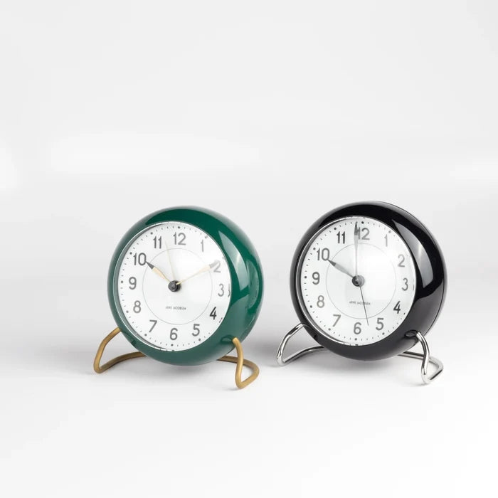 Classic Arne Jacobsen "AJ" Alarm Clock in green and black on white background.  AA batteries not included.