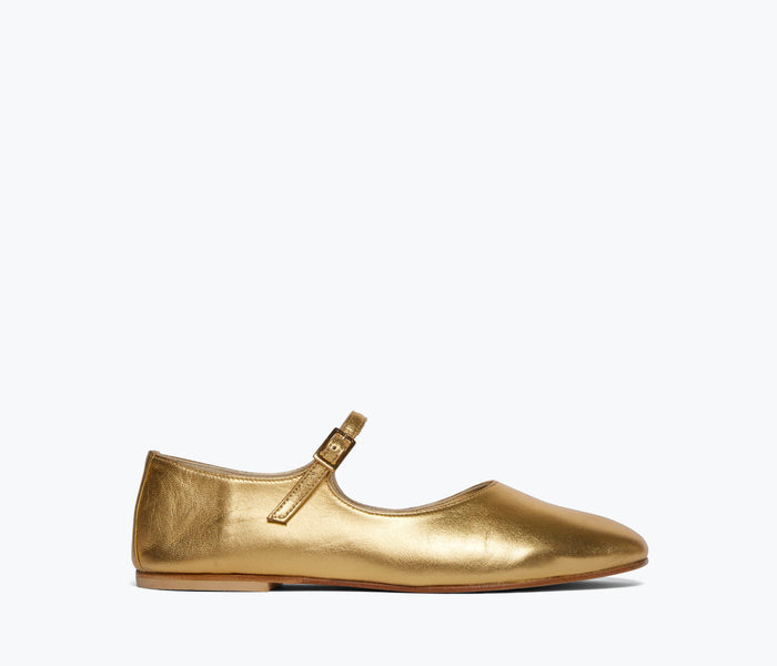 Gold Aubrey Mary Jane flat by Freda Salvador, showcasing the exterior side view with a sleek design and ankle strap detail.