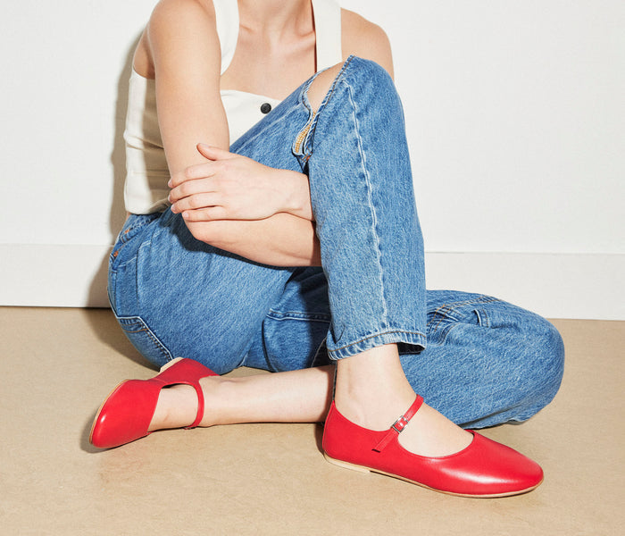Freda Salvador Aubrey Mary Jane flat shoe in neutral color with rounded toe and strap detail, styled on a wooden surface.