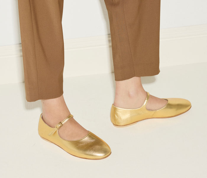 Freda Salvador Aubrey Mary Jane flat in gold with a sleek strap and rounded toe, stylish and comfortable footwear.