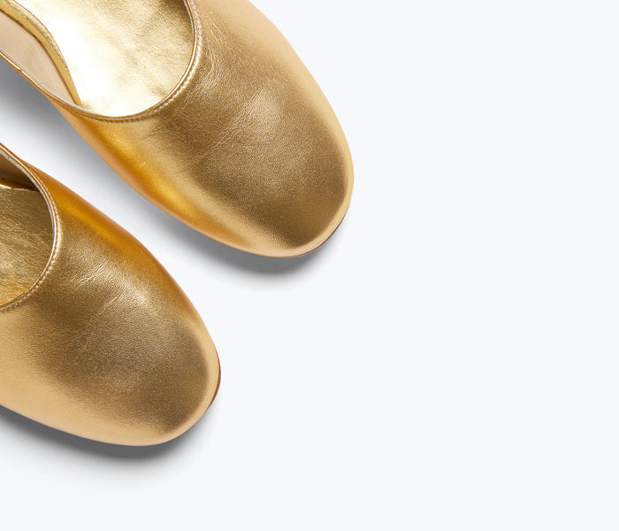 Gold calf leather Aubrey Mary Jane flat by Freda Salvador with a sleek, minimalist design and rounded toe.