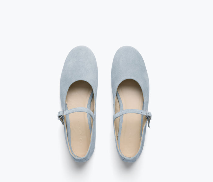 Blue suede Aubrey Mary Jane flat by Freda Salvador, featuring a classic strap and rounded toe, on a white background.