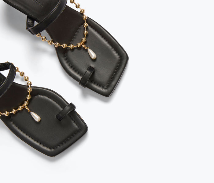 FREDA SALVADOR Aurora black heel sandal with calf chain detail, stylish open-toe design and elegant ankle strap.