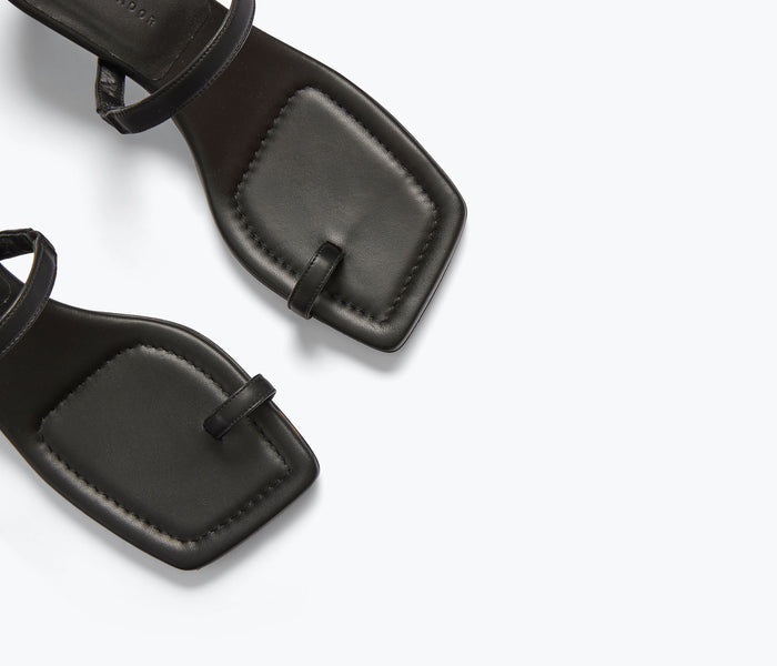Black leather AURORA sandal heel by FREDA SALVADOR with detailed calf leather strap and elegant design.