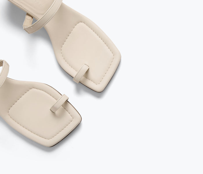 Close-up of FREDA SALVADOR Aurora Sandal heel in macadamia color, showing detailed calf strap and elegant design.