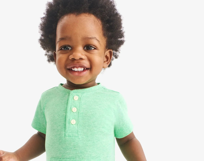 Child wearing Primary Baby Henley Romper - Clover. Available at www.tenlittle.com