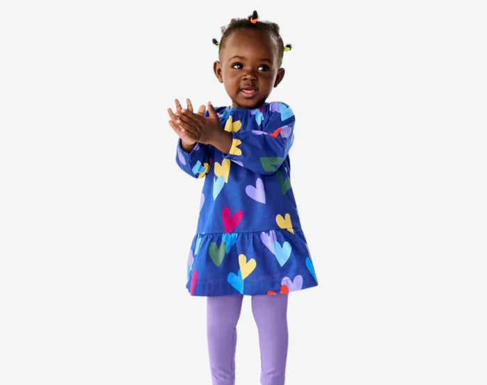 Girl wearing Primary Baby Leggings - 3 Pack - Warm Mix. Available at www.tenlittle.com