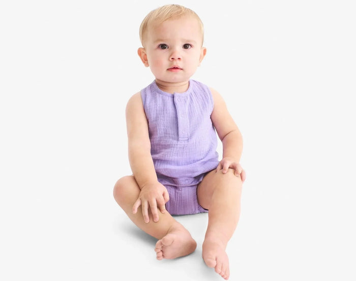 Baby sitting wearing Primary Baby Sleeveless Romper - Iris. Available at www.tenlittle.com