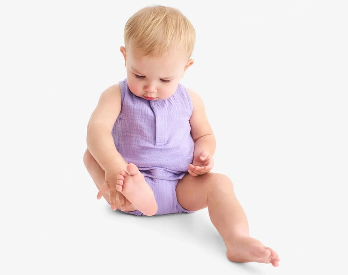 Baby sitting wearing Primary Baby Sleeveless Romper - Iris. Available at www.tenlittle.com