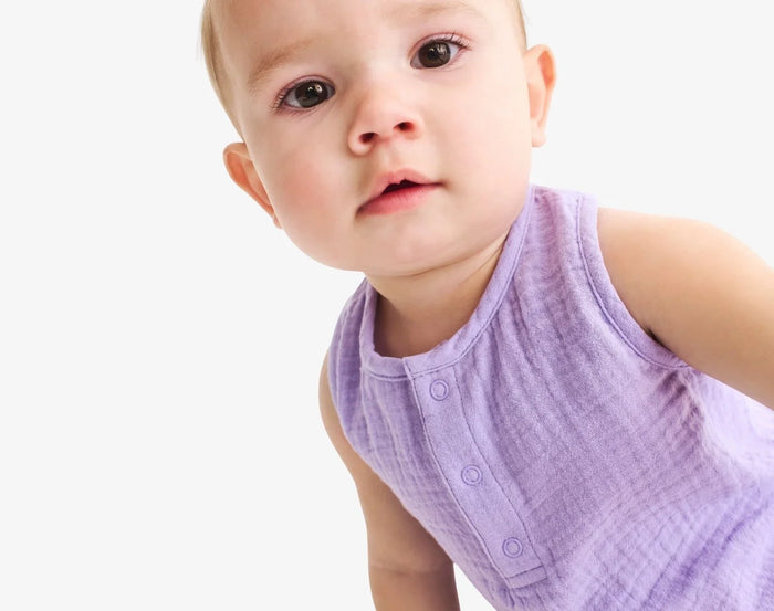 Baby wearing Primary Baby Sleeveless Romper - Iris. Available at www.tenlittle.com