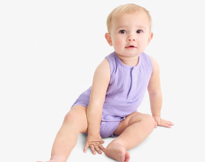 Baby sitting wearing Primary Baby Sleeveless Romper - Iris. Available at www.tenlittle.com