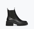 Black Bailey studded rain-resistant boot by Freda Salvador, front view showing studded detail and waterproof design.
