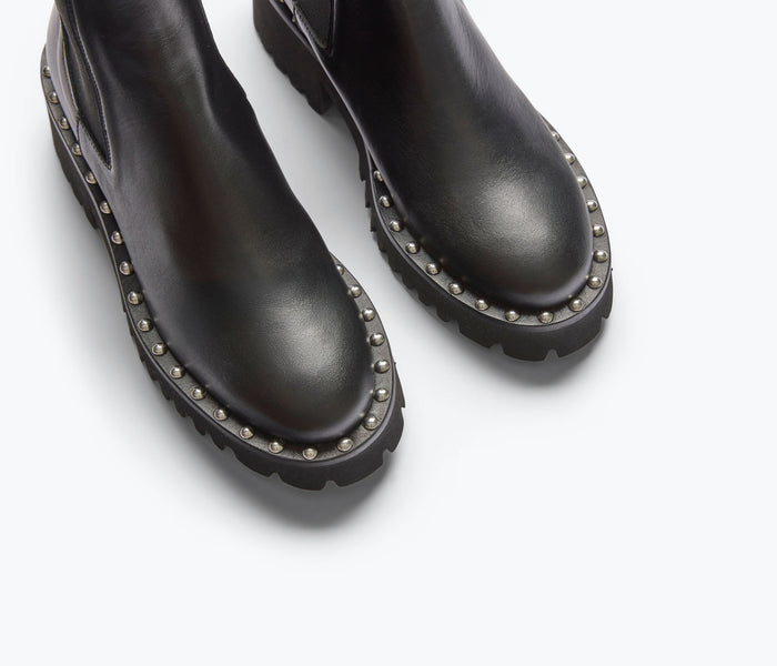 Black Bailey studded rain-resistant boot by Freda Salvador with calf-length design and decorative metal studs.