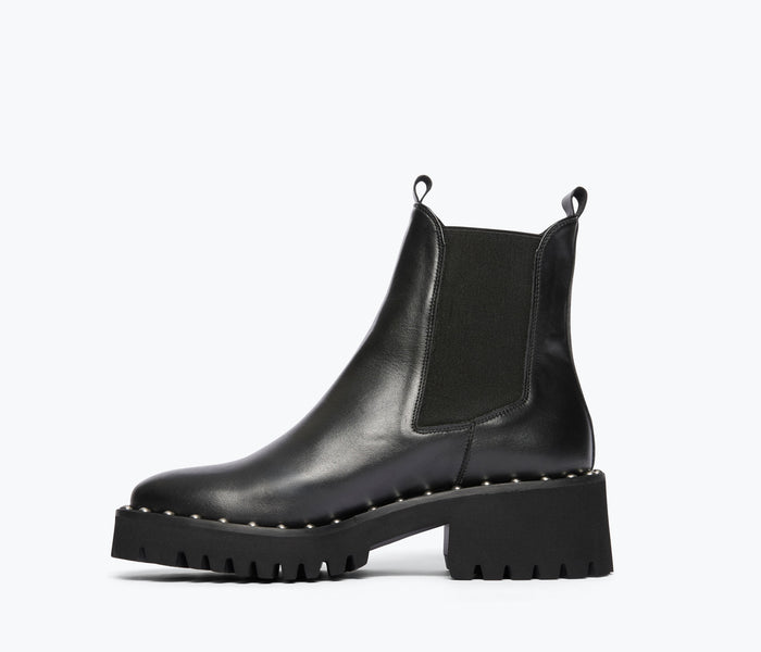 Black Bailey studded rain-resistant boot by Freda Salvador, showing inside view with calf height and studded detailing.