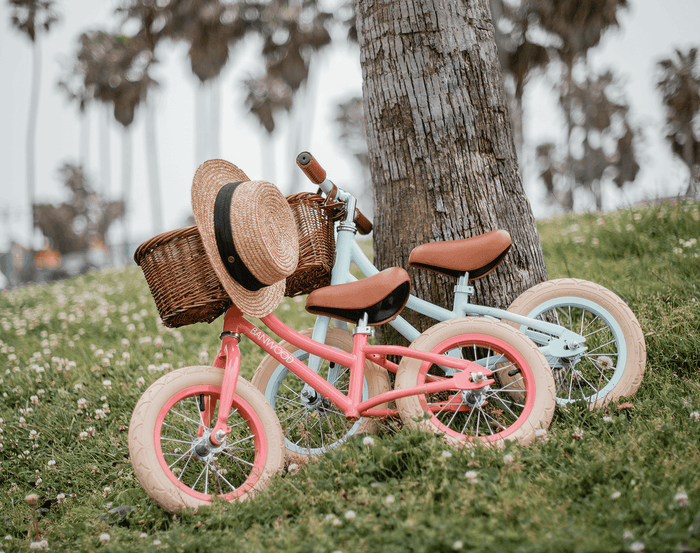 Banwood Balance Bike Mint and Coral Parking Under the tree. Available at www.tenlittle.com