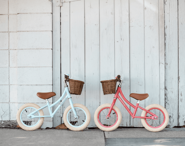 Banwood Balance Bike Sky Blue and Coral Parking towards each other. Available at www.tenlittle.com