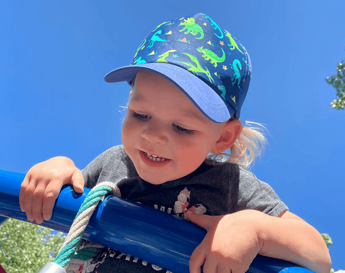 Boy wearing Jan & Jul Baseball Cap - Dinoland. Available at www.tenlittle.com