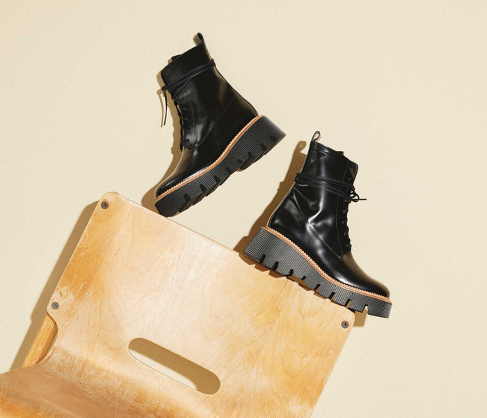 Black Billie platform combat boot by FREDA SALVADOR with chunky sole and lace-up design, styled for a bold, edgy look.