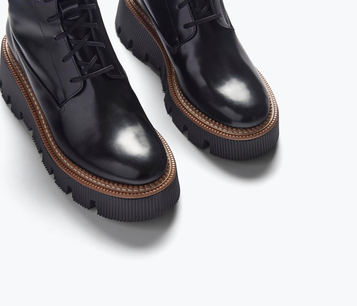 Black FREDA SALVADOR Billie platform combat boot with detailed stitching and sturdy sole.