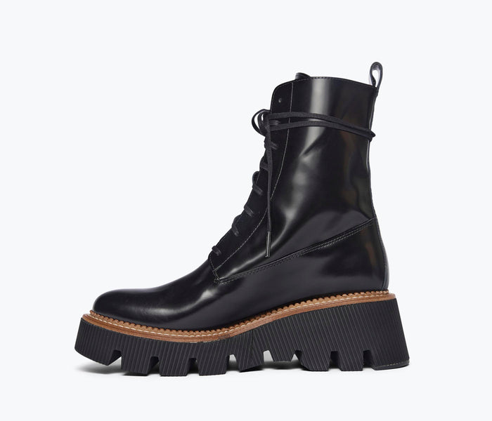 Black FREDA SALVADOR Billie Platform Combat Boot with inside view showing sturdy sole and ankle height.