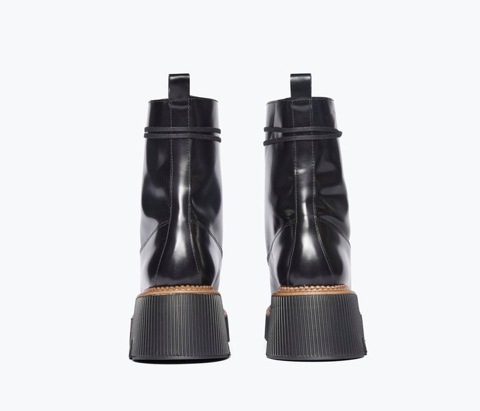 Black FREDA SALVADOR Billie Platform Combat Boot shown from the back, featuring chunky sole and combat style design.