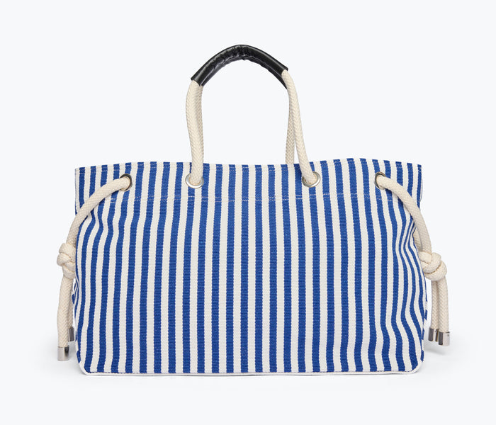 Navy and white canvas Birdie handbag by Freda Salvador with front view showing tote style and natural canvas texture.