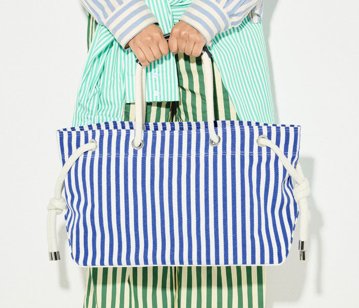 Navy and white canvas Freda Salvador Birdie tote handbag with sturdy handles and spacious interior.