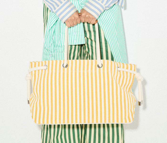 Mustard and white canvas Birdie tote handbag by Freda Salvador with sturdy handles and spacious interior.