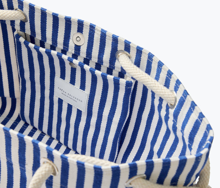Navy and white canvas Birdie tote handbag by Freda Salvador with interior view showing spacious storage and stylish design.