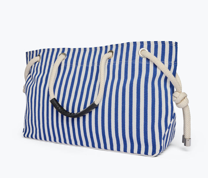 Navy and white canvas Freda Salvador Birdie handbag with side view showing tote style and stitched details.