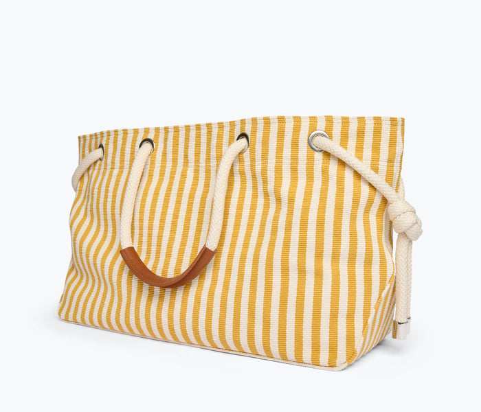 Mustard and white canvas Birdie tote handbag by Freda Salvador, side view showing spacious interior and sturdy handles.