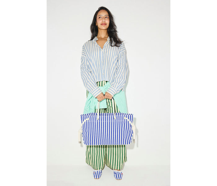Navy and white canvas Birdie tote handbag by Freda Salvador with sturdy handles and minimalist design.