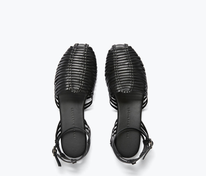 Black caged woven flat shoe by FREDA SALVADOR featuring intricate woven design and open toe style.