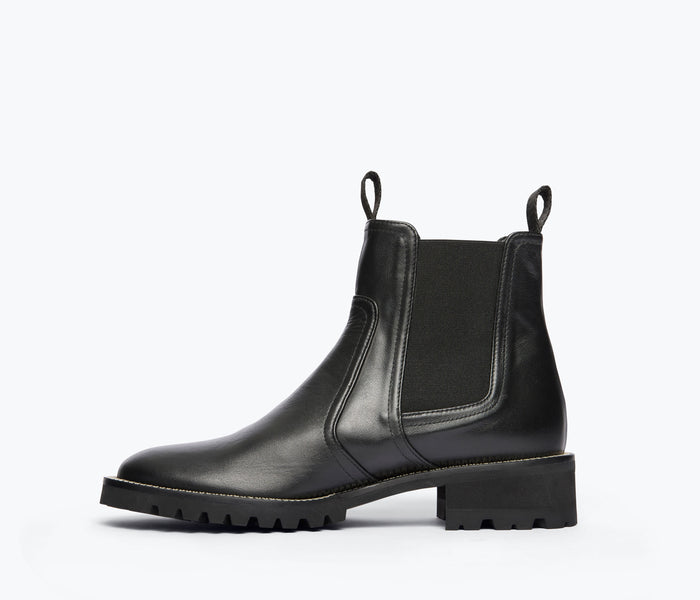 Black Bonnie rain-resistant boot by Freda Salvador shown from inside view with detailed leather interior and stitching.
