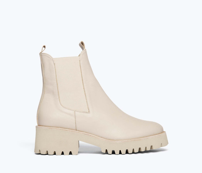 Cream Freda Salvador Brooke rain-resistant boot with a sleek front view, showcasing its stylish design and waterproof material.