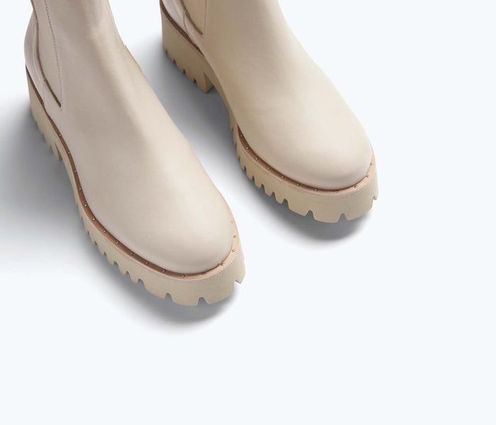 Cream FREDA SALVADOR Brooke rain-resistant boot with detailed stitching and waterproof design, perfect for wet weather.