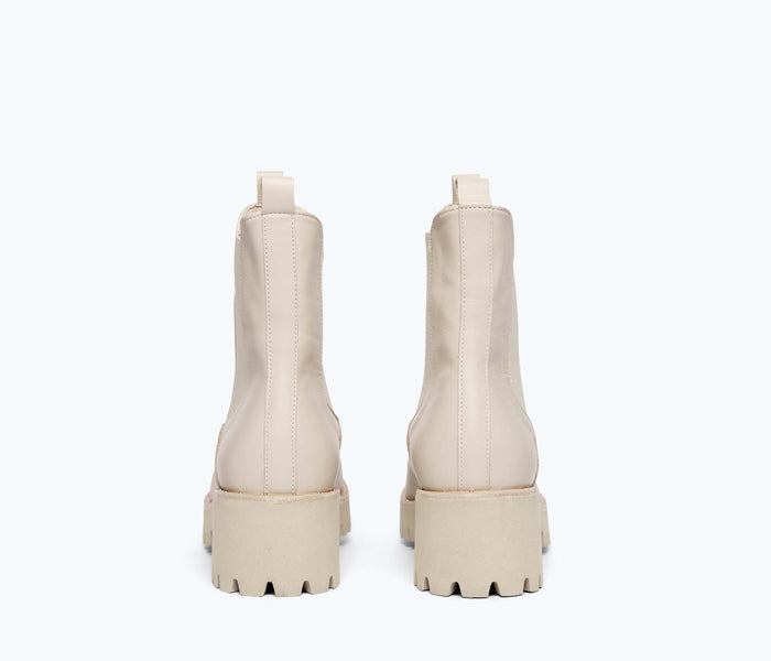 Freda Salvador Brooke rain-resistant boot in cream color, back view showing sturdy sole and waterproof material.