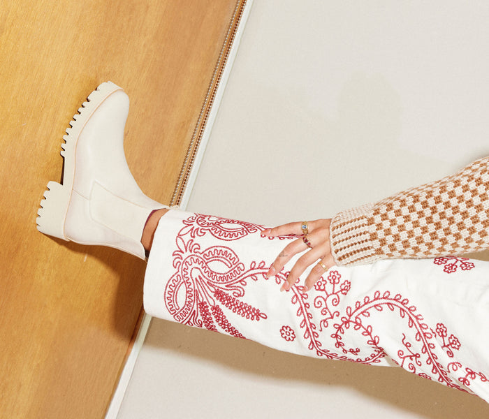 Cream rain-resistant boot from FREDA SALVADOR's BROOKE collection, featuring a stylish design and waterproof material.
