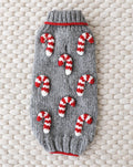Red and white striped knit dog sweater for holiday festivities.