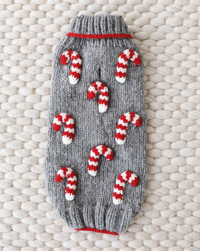 Red and white striped knit dog sweater for holiday festivities.
