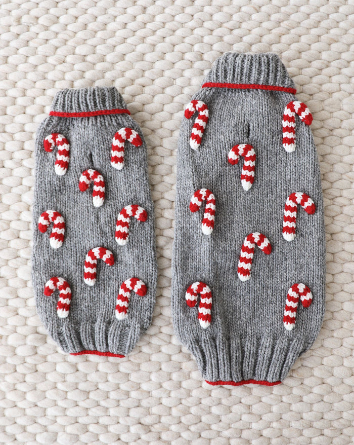 Holiday-themed red and white dog sweater in knit pattern.