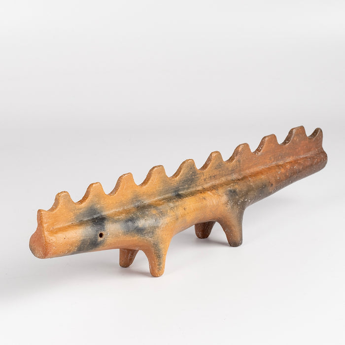 Ceramic Creature 10 is a figurine fformed from solid clay and refined by hand, this "one of a kind" ceramic creature is made out of red earthenware and red terra sigillata before getting pit fired in the wilderness. Made by Carol Horst in Los Angeles.