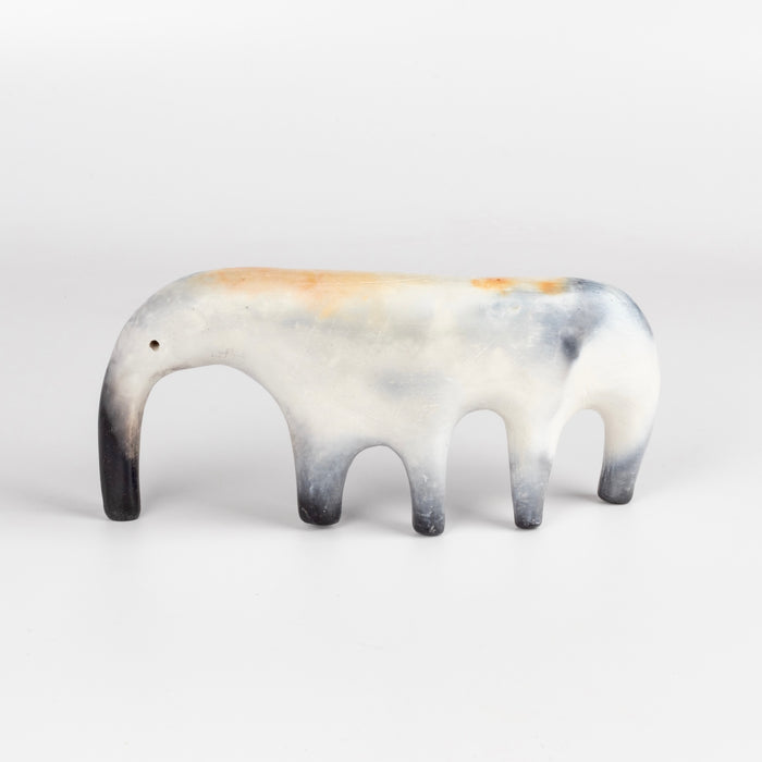 An ambigous ceramic creature  figurine formed from solid clay and refined by hand, this "one of a kind" ceramic creature is made out of white earthenware and white terra sigillata before getting pit fired in the wilderness. Made by Carol Horst in Los Angeles.