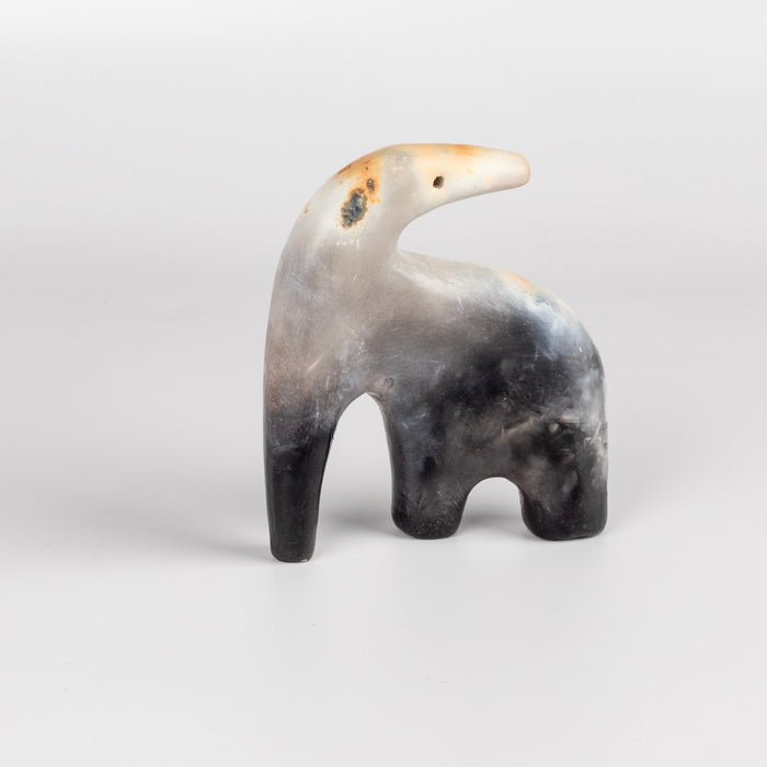 The ceramic creature is a one of a kind figurine formed from solid clay and refined by hand, this "one of a kind" ceramic creature is made out of white earthenware and white terra sigillata before getting pit fired in the wilderness. Made by Carol Horst in Los Angeles.