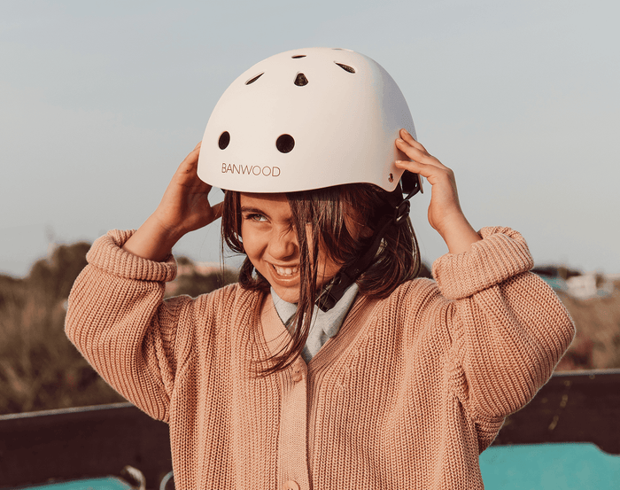Child wearing Banwood Classic Helmet white - Available at www.tenlittle.com