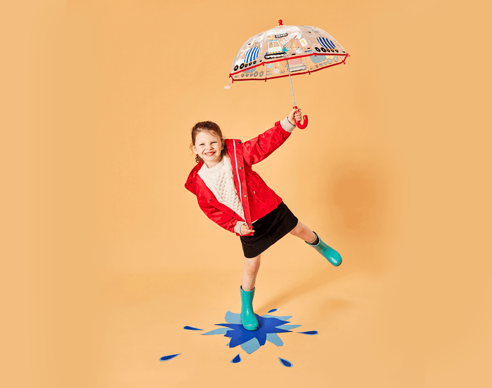 Little girl holding Ten Little Color Changing Umbrella Construction - Available at www.tenlittle.com