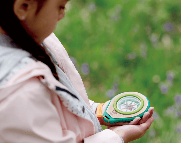 Child using Hape Compass Set. Available at www.tenlittle.com
